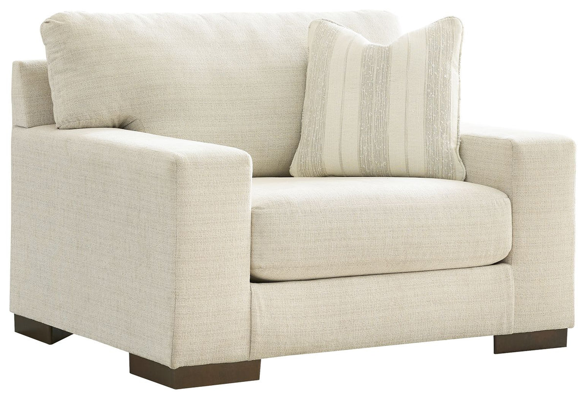Light beige chair and a half with striped throw pillow and dark wood legs