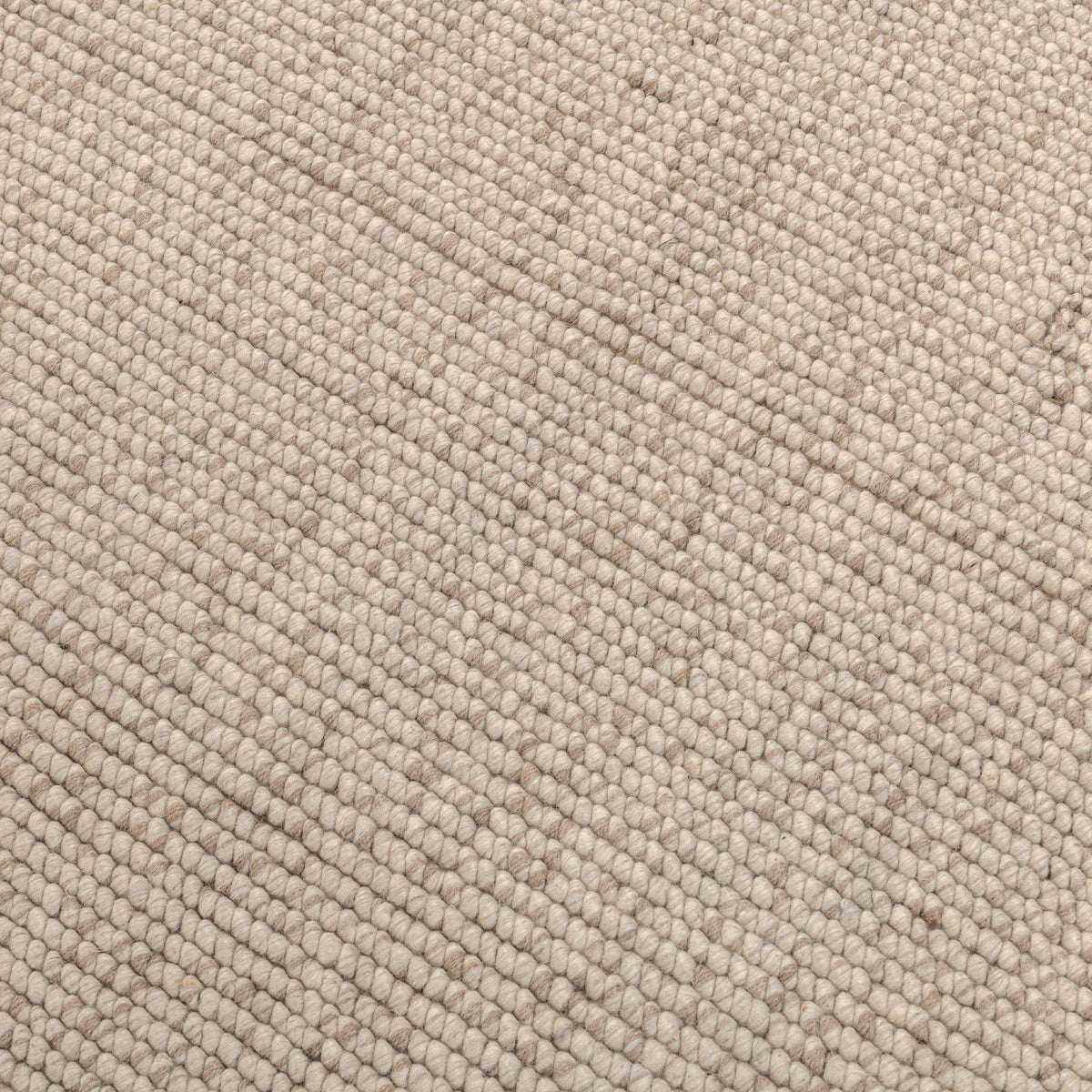 Natural woven rug close-up with textured speckle pattern