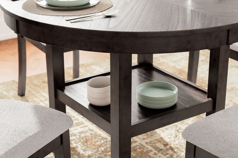 Brown dining table with open shelf and gray upholstered chair corner view