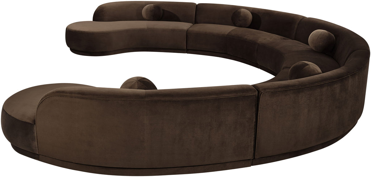 Dark brown velvet upholstered sectional sofa, curved corners, and tufted back cushions