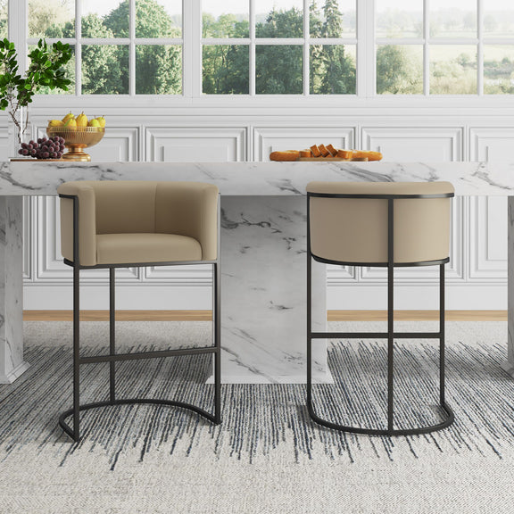 Pair of beige upholstered barstools with black metal frames and curved footrests