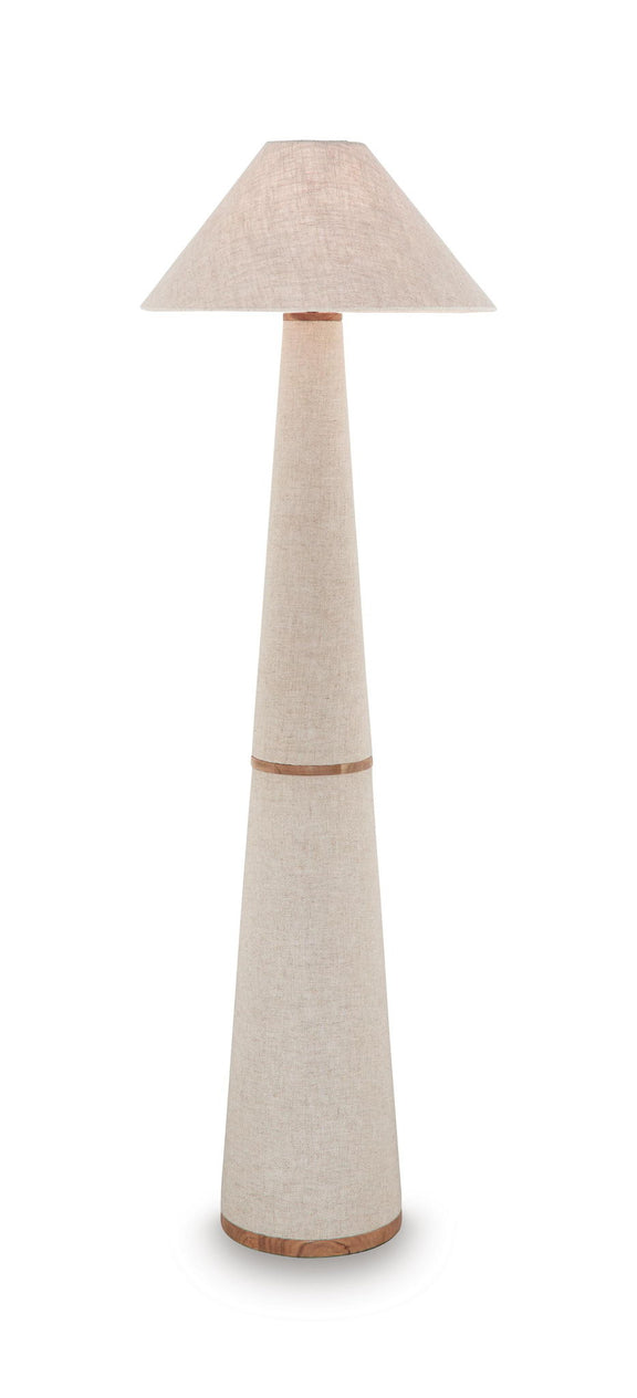 Beige fabric lampshade on tall metal lamp with slender stem and wood-tone base ring