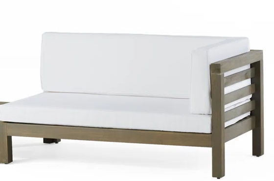 Corner bench with white cushion and light wood slatted coffee table