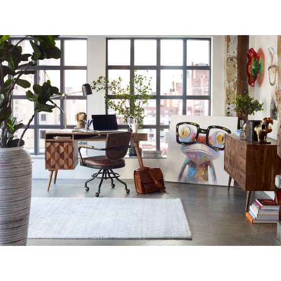 Caramel brown wooden desk with carved side cabinets, flat top, and angled legs