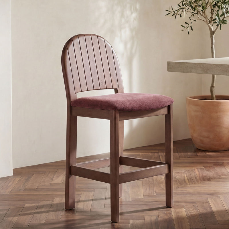 Dark wood counter stool with arched slatted back and berry seat cushion