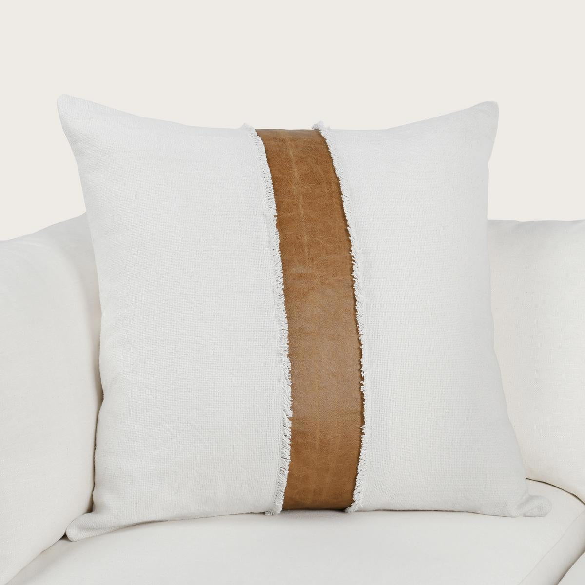 Pillow with dark brown center stripe and frayed edges, white cover