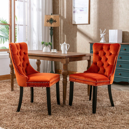 Tufted dining chairs, orange upholstered seats with nailhead trim and dark legs (pair)
