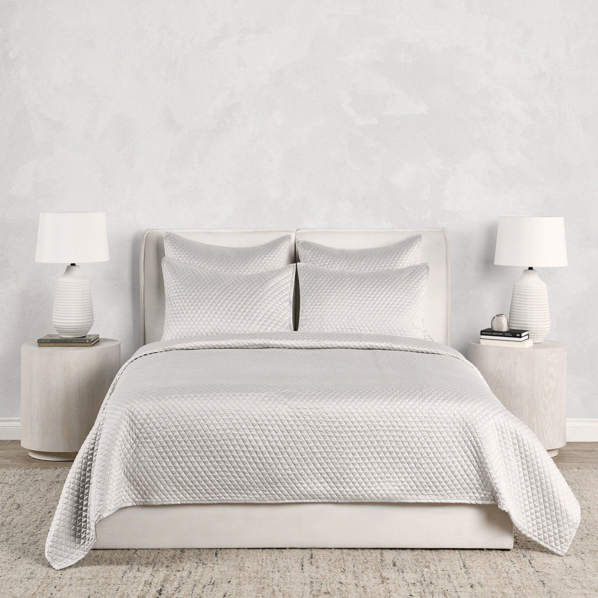 Diamond-quilt duvet and pillow shams in white, with stitched diamond texture across bedding