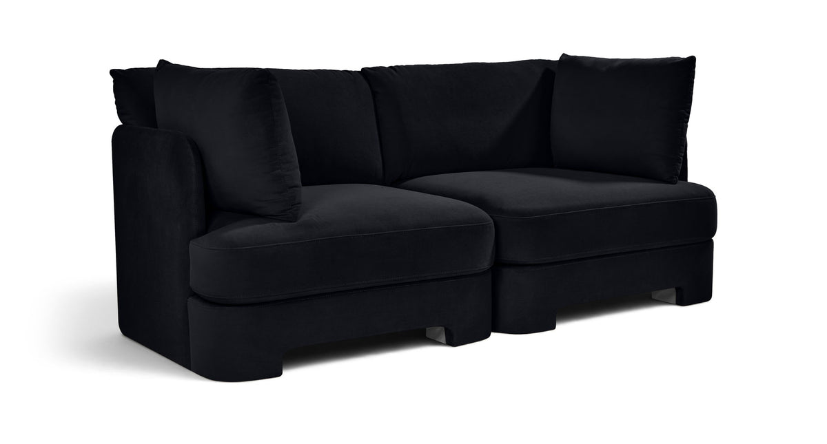 Black velvet upholstered 2-piece loveseat with two seat sections and bolster pillows