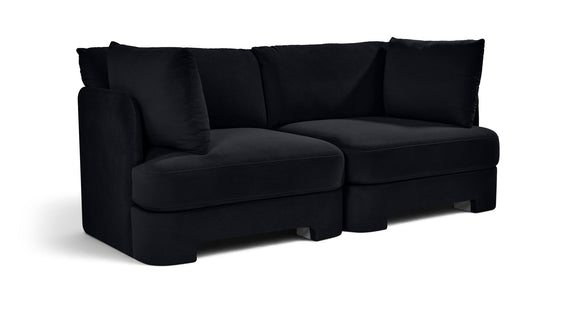 Black velvet upholstered 2-piece loveseat with two seat sections and bolster pillows