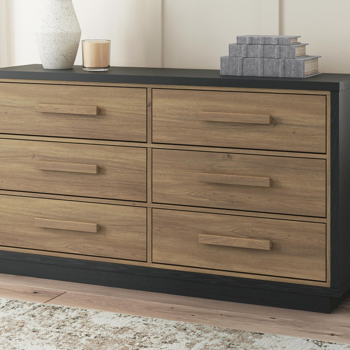 Black frame six-drawer dresser with light brown wood drawers and bar pulls