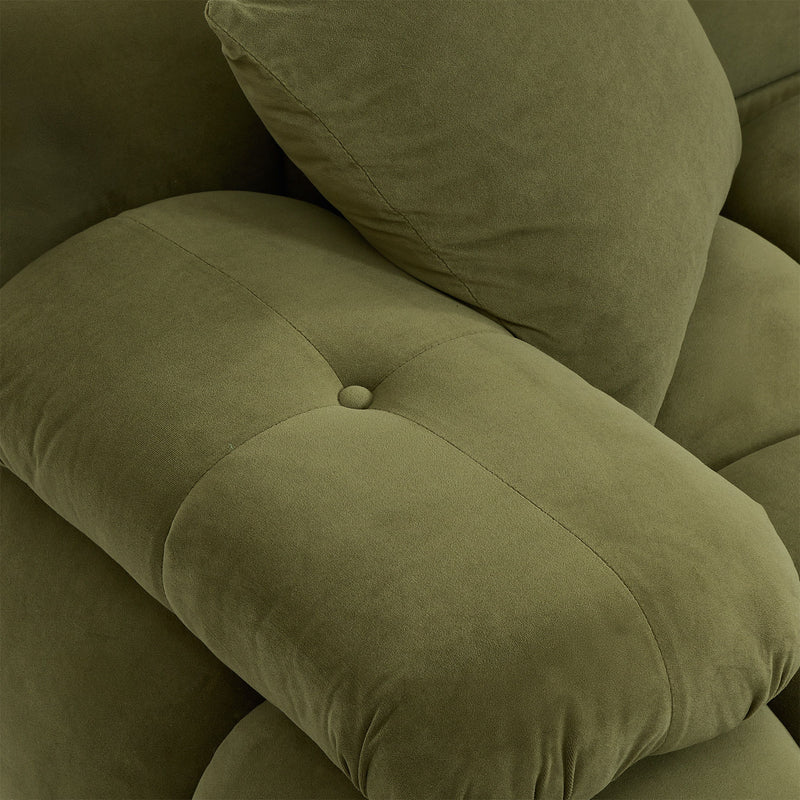 Olive green sofa cushion close-up with stitched seams and soft textured fabric