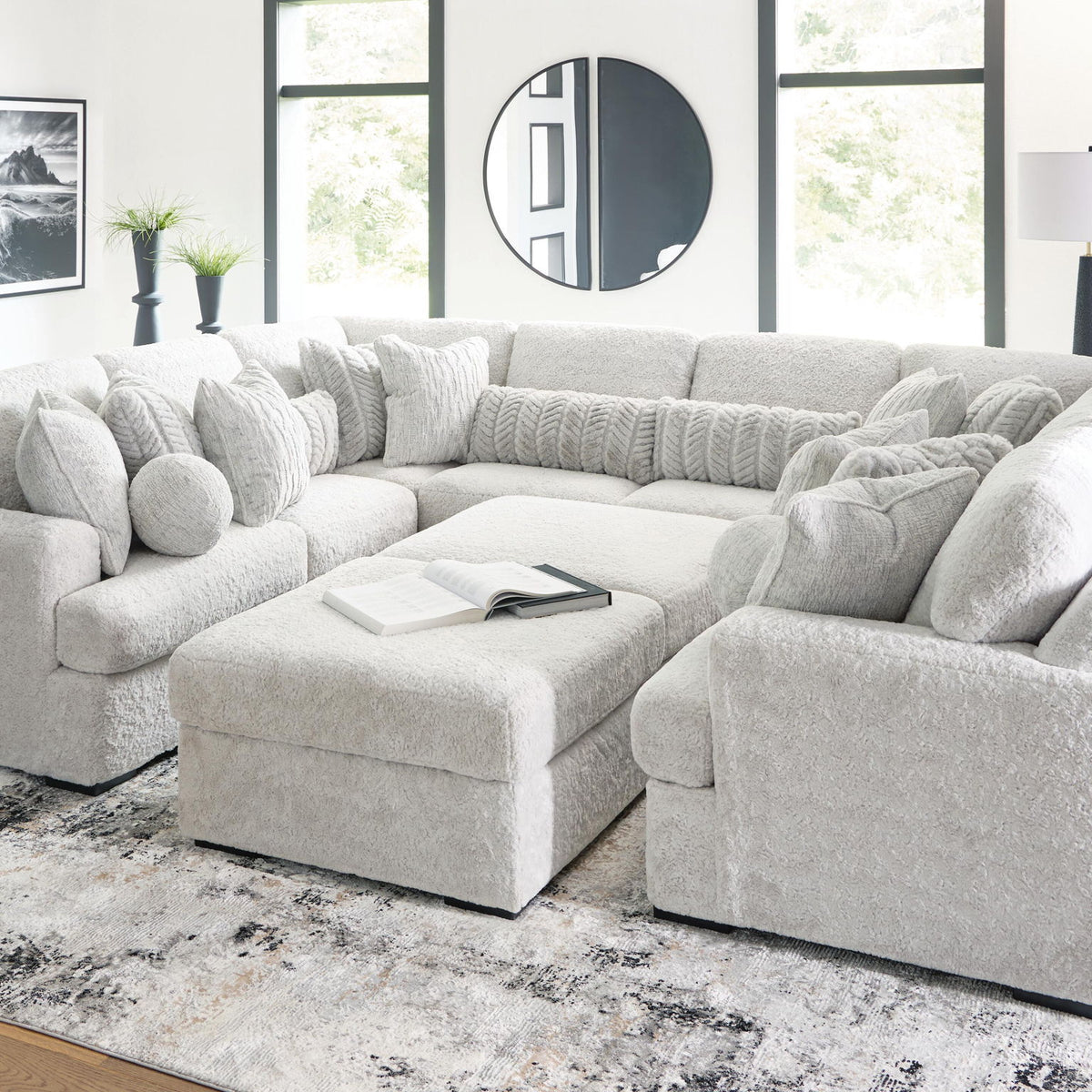 White sectional sofa with long chaise and ottoman-style seats with plush cushions