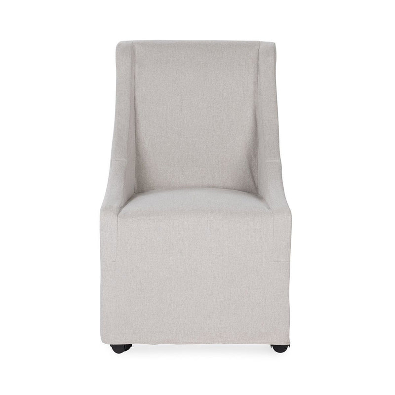 Upholstered rolling dining chair in pale gray fabric, tall back and padded armrests