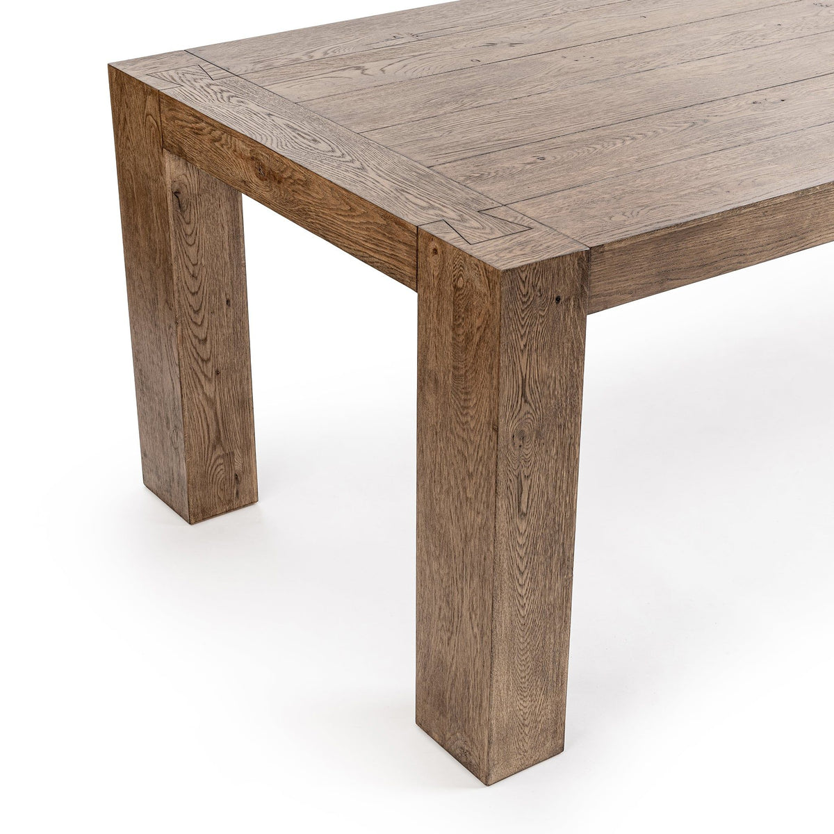 Natural oak dining table with visible wood grain, corner detail and straight legs