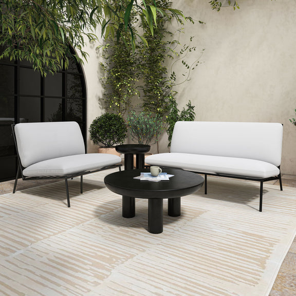 Round black cement coffee table with wide tabletop and central three-leg base