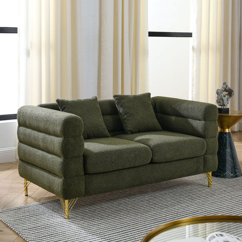 Dark green sectional sofa with rounded arms, tufted seat cushions, and gold legs