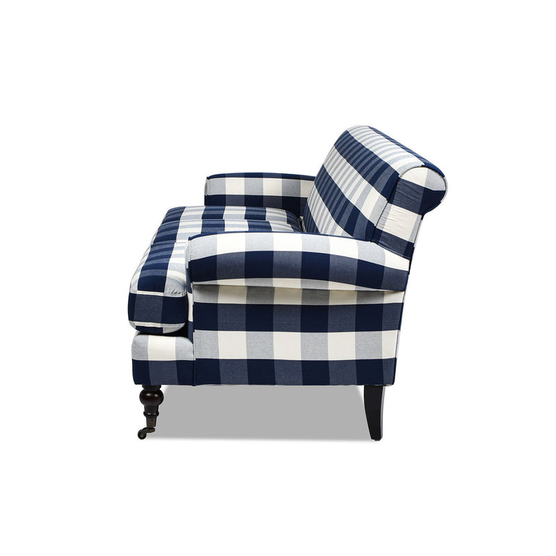 Blue and white plaid upholstered armchair with rolled arms and turned wooden legs.