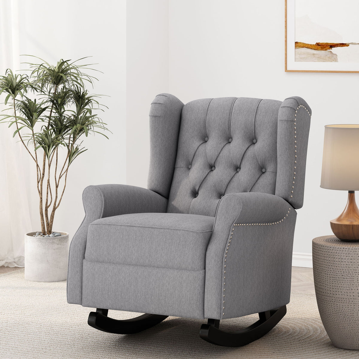 Gray fabric rocking chair with button-tufted back, winged sides, and nailhead trim