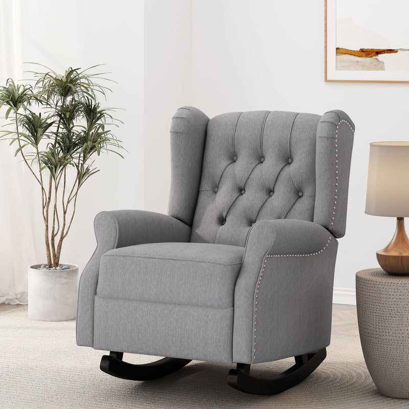 Gray fabric rocking chair with button-tufted back, winged sides, and nailhead trim