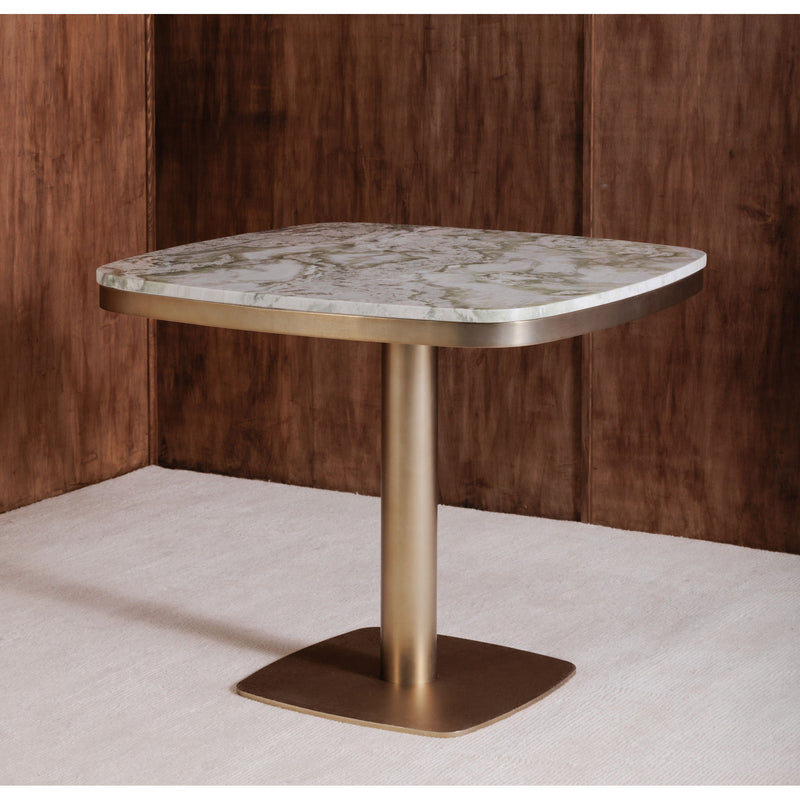 Corner view of round cafe table with green marble-look top and antique brass base