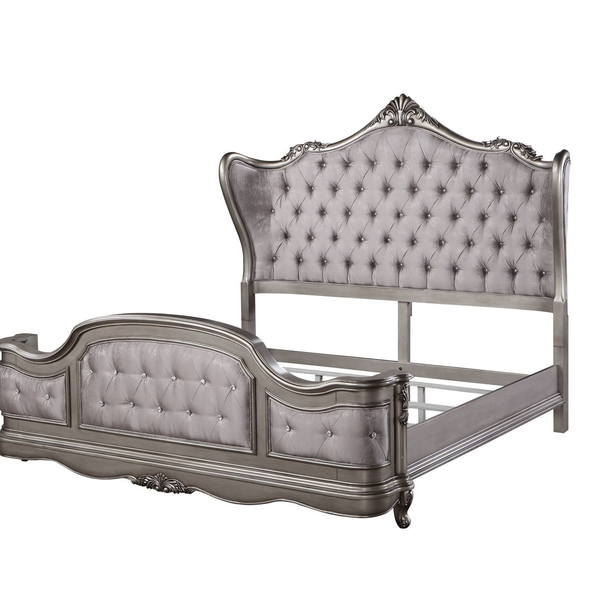 Silver tufted upholstered bed with ornate headboard, curved footboard, and side rails