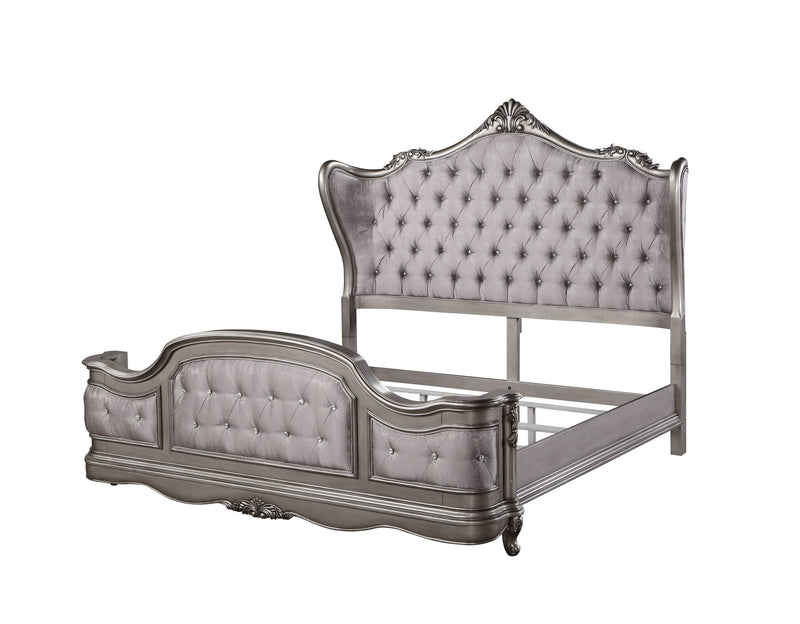 Silver tufted upholstered bed with ornate headboard, curved footboard, and side rails
