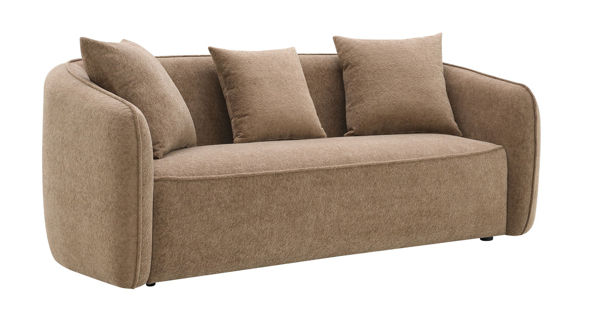 Tan upholstered sofa with four matching toss pillows and rounded arm profile