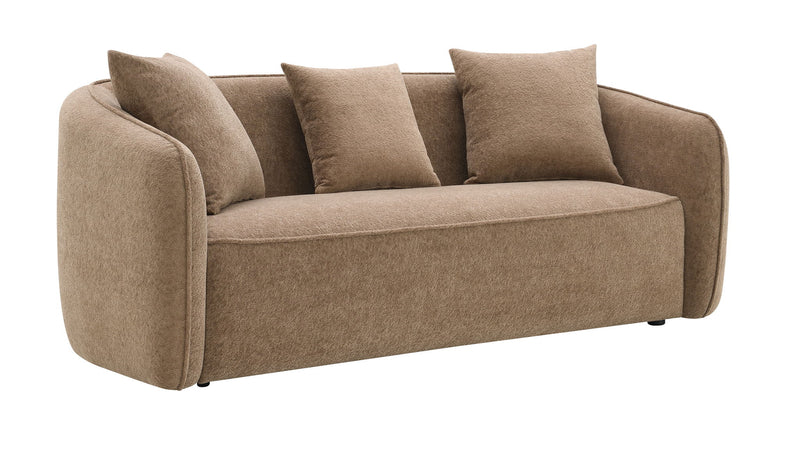 Tan upholstered sofa with four matching toss pillows and rounded arm profile