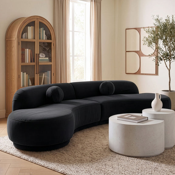 Black velvet performance sectional sofa with rounded chaise and bolster pillows