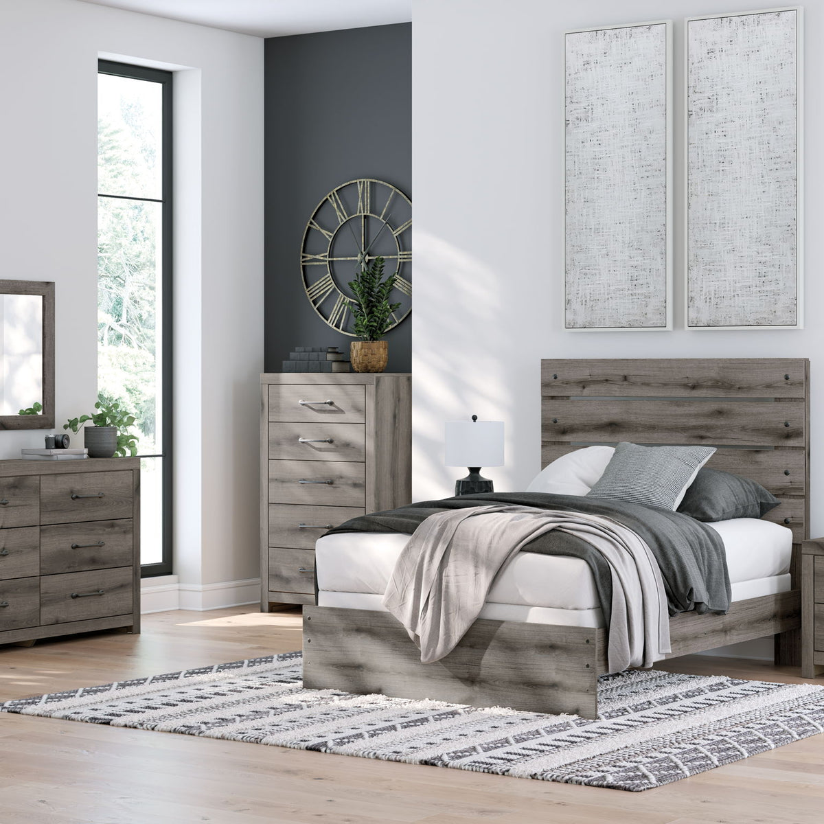 Rectangular wall mirror with dark gray wood frame in a bedroom setting