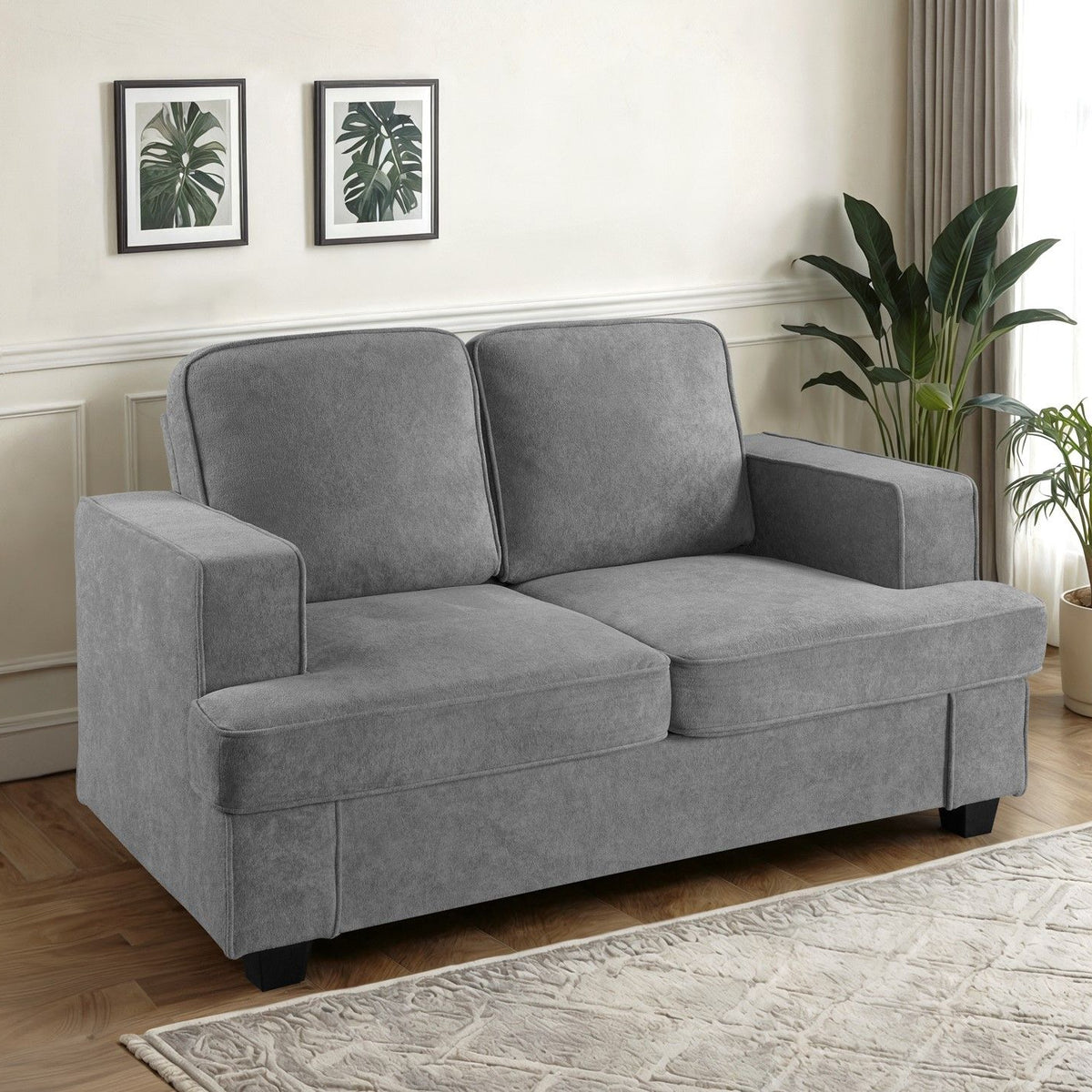 Dark gray 2-seat loveseat sofa with wide arms and two back cushions, plush seat.