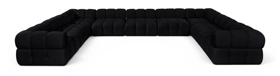 Black velvet upholstered sectional sofa with tufted cushions and rounded corner arms