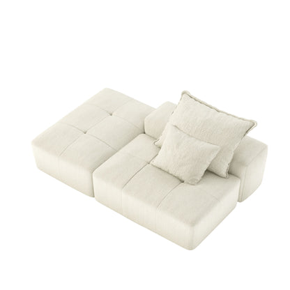 Modular sectional sofa with two throw pillows in beige fabric upholstery