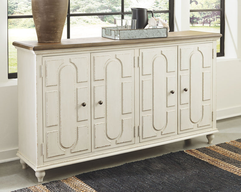 Antique white accent cabinet with carved door panels and four dark knobs