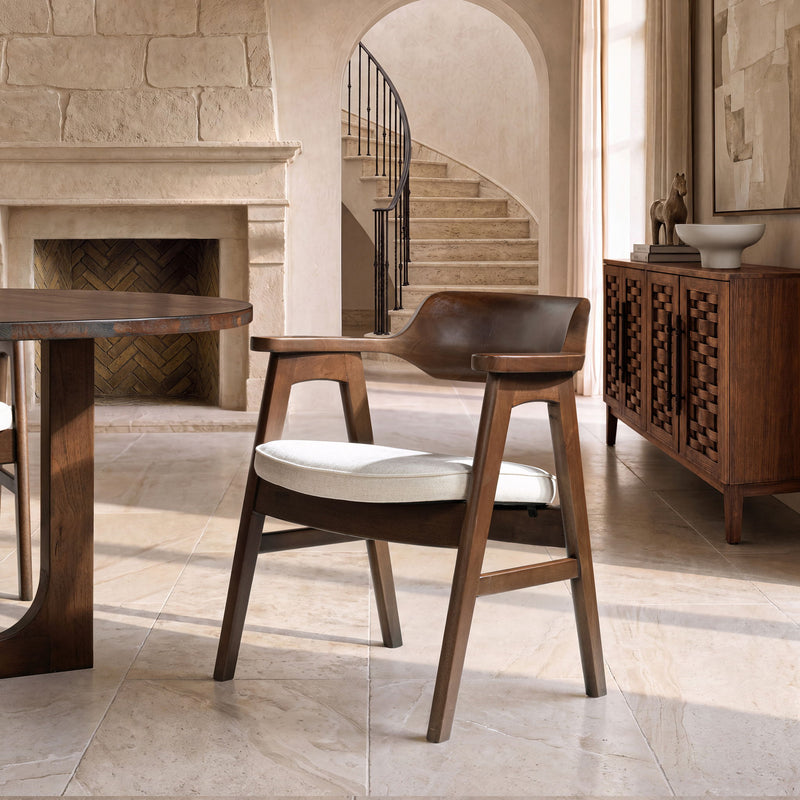 Dark wood dining arm chair with curved back and light beige seat cushion
