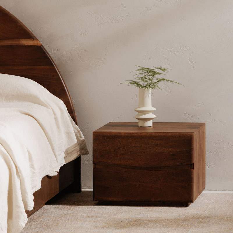 Brown wooden nightstand with one drawer and a vase on top