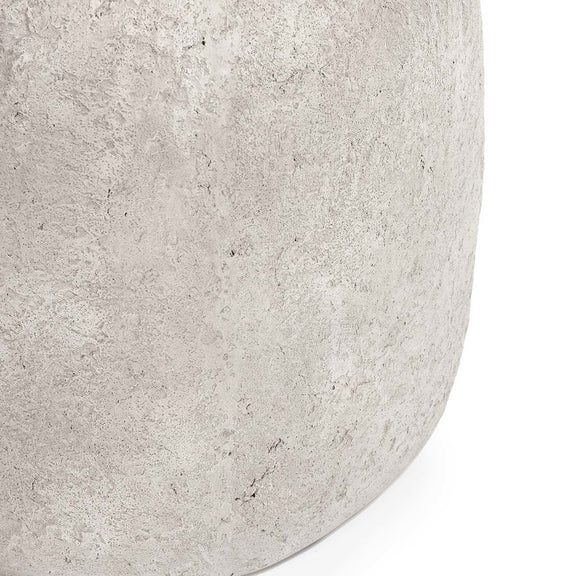 Light gray end table close-up of curved edge with textured concrete speckles
