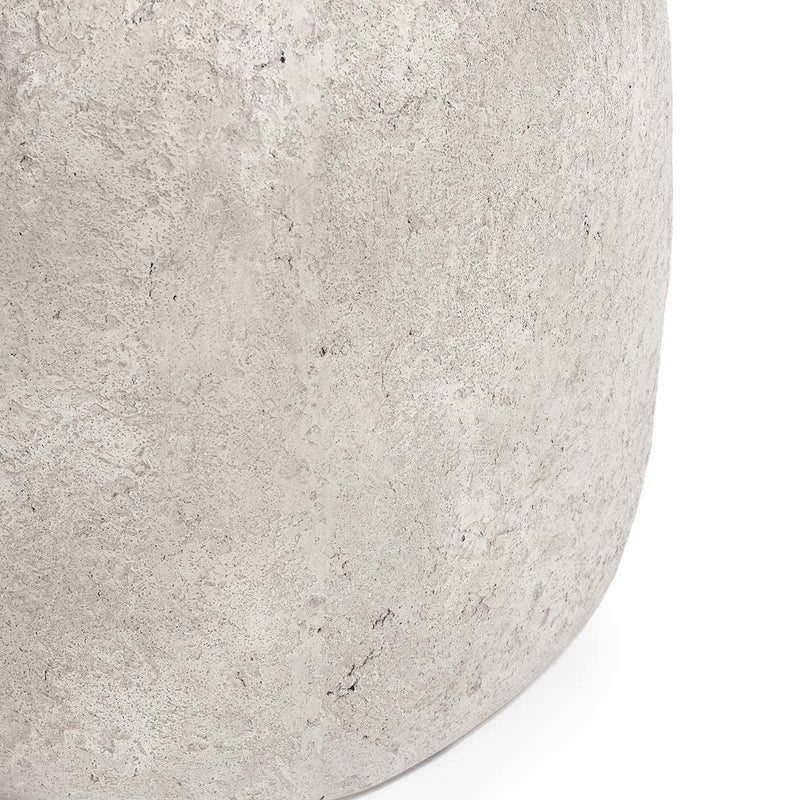 Light gray end table close-up of curved edge with textured concrete speckles