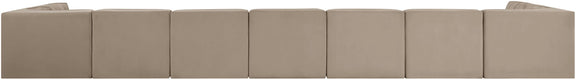 Beige modular sectional sofa with multiple seat cushions and tufted back panels