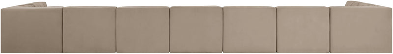 Beige modular sectional sofa with multiple seat cushions and tufted back panels