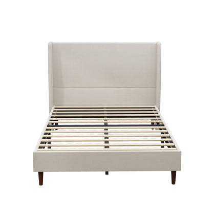 Beige upholstered bed with tall headboard, wooden slats, and tapered legs