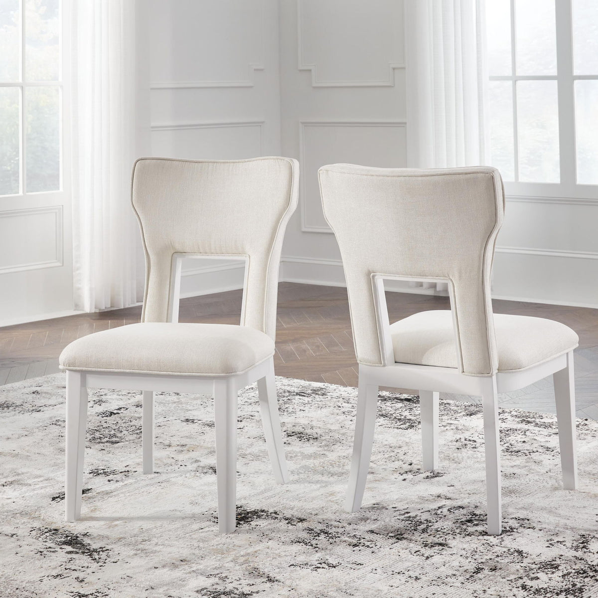 Set of 2 upholstered dining side chairs, white frame, light beige seats and backs