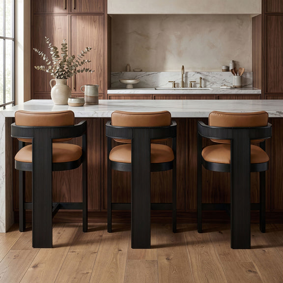 Set of 3 vegan leather counter stools with tan upholstered seats and black ribbed bases