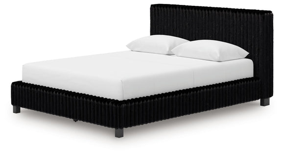 Black upholstered bed with white mattress and two pillows, ribbed frame
