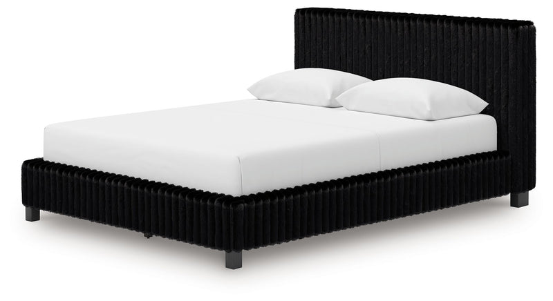 Black upholstered bed with white mattress and two pillows, ribbed frame
