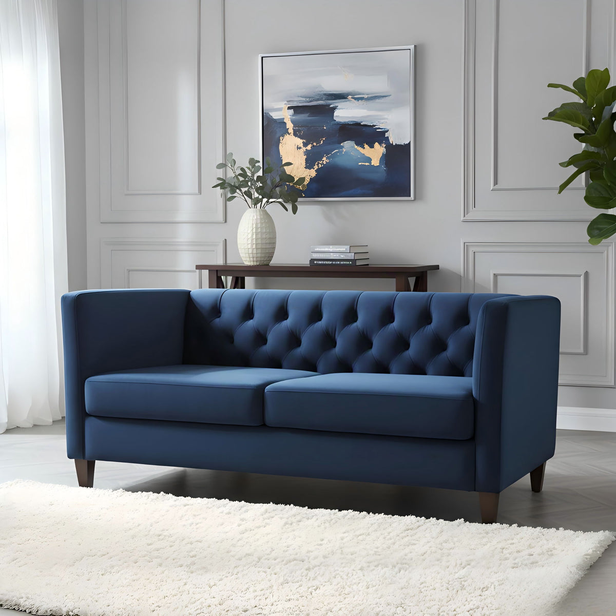Blue button-tufted 3-seat sofa with deep button back, wide arms, and dark legs