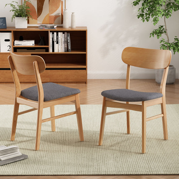 Set of 2 dining chairs with dark gray seat cushions and curved light wood backs