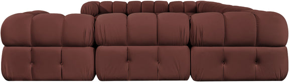 Burgundy velvet sectional sofa with tufted cushions and rounded chaise sections