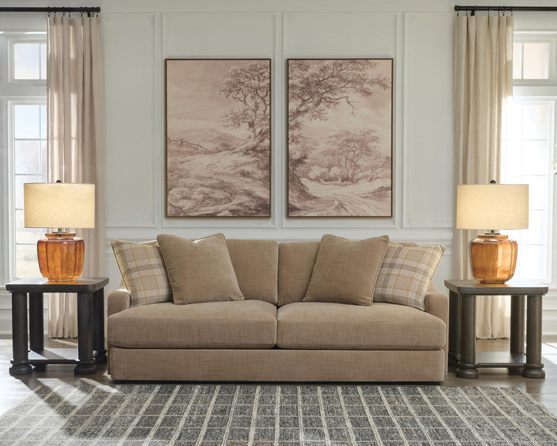 Beige fabric sofa with cushioned arms and plaid and solid throw pillows